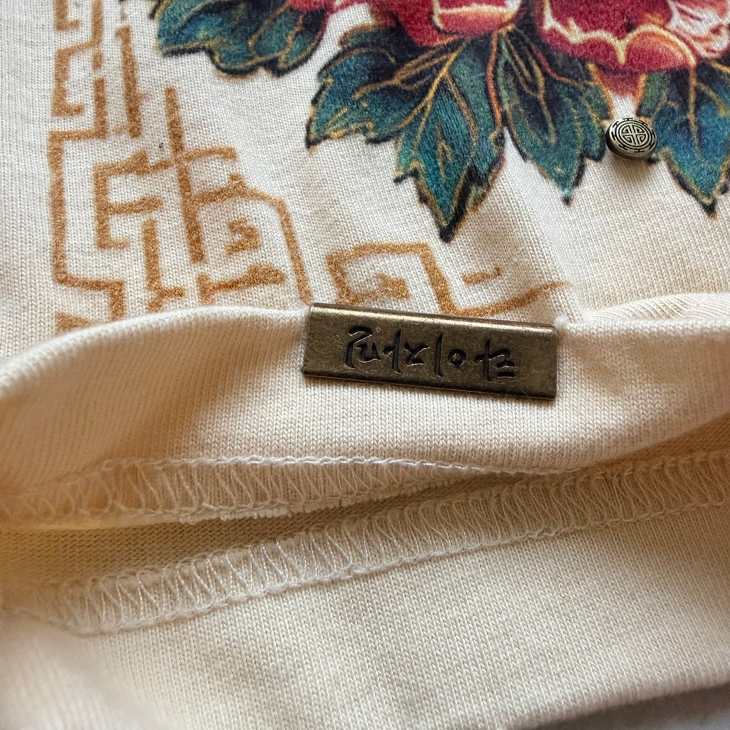 Reverse of the branded metal hem detail on the Babo Horangi Tee